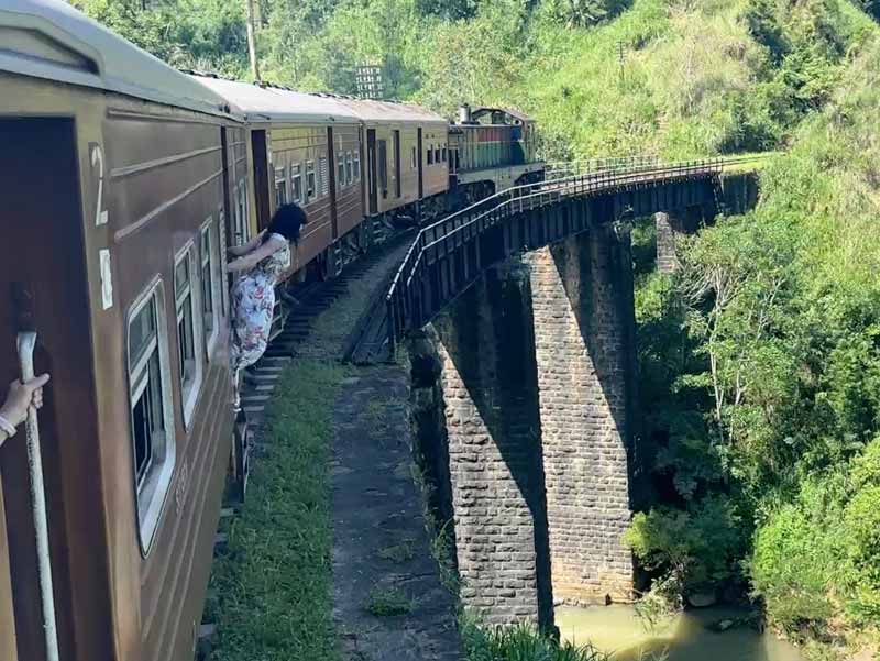 Hanging out of the train door in Sri Lanka Adventure travel - Sri Lanka trains