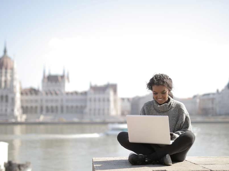 Lady working on a laptop by river