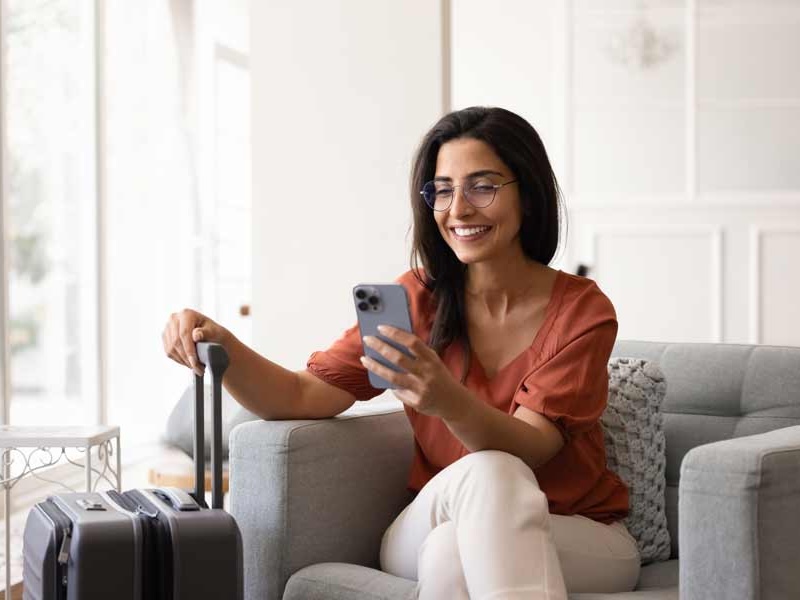 worldwide esims Lady on phone in airport lounge